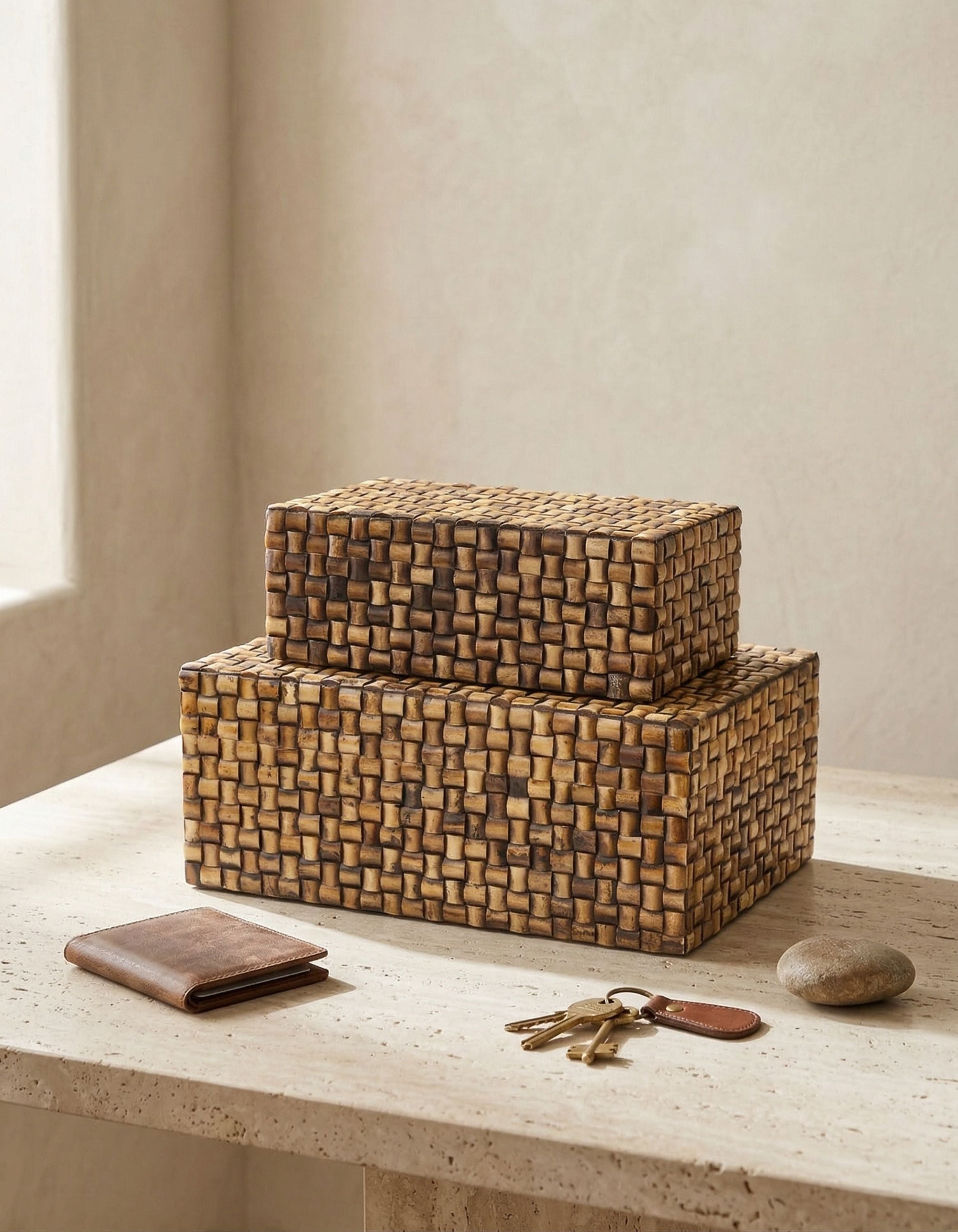 Set of two carved bone inlay decorative boxes with woven pattern in warm natural tones, styled on a stone surface with everyday essentials
