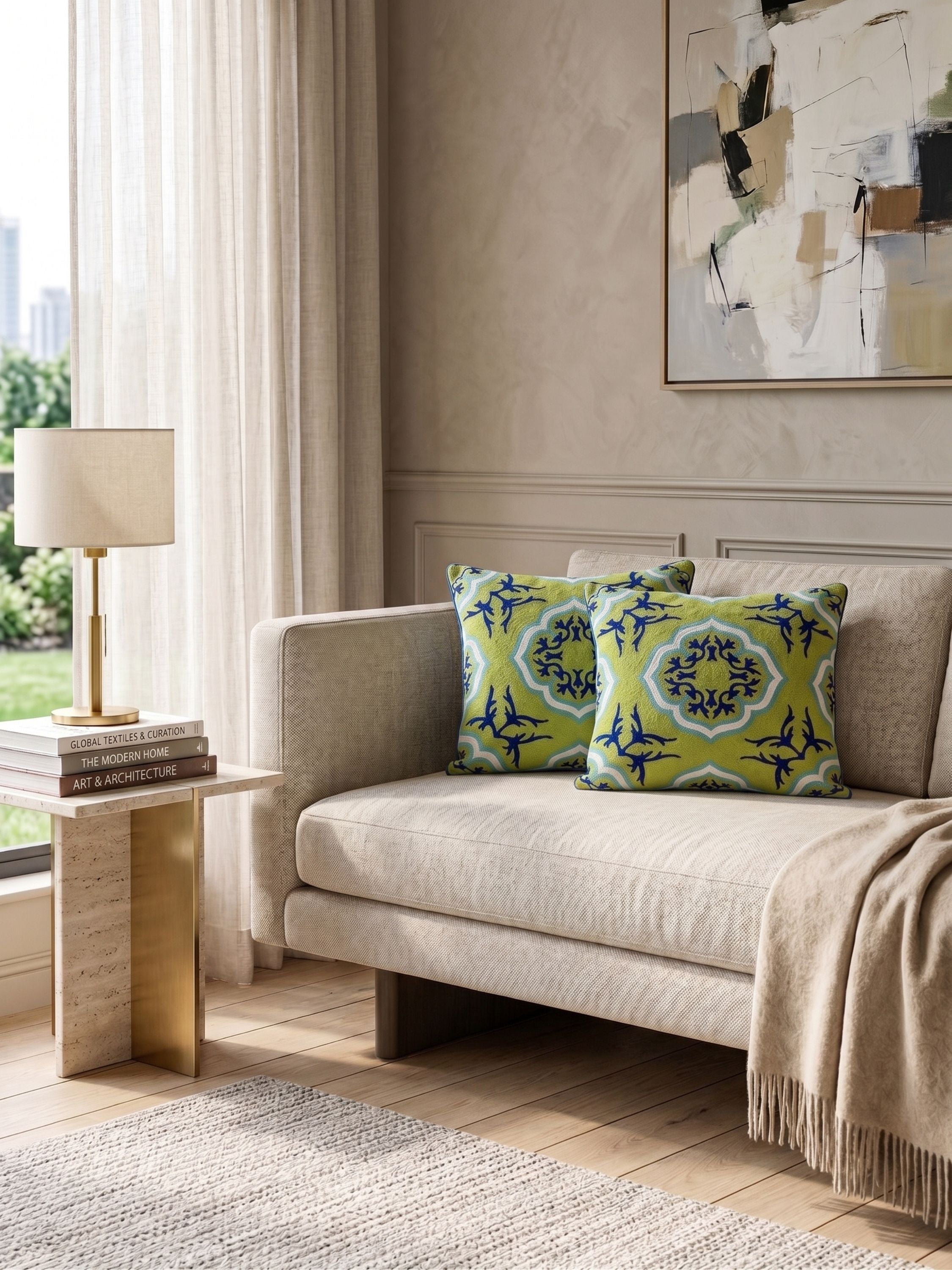 Lifestyle view of cotton and wool pillow highlighting continuous embroidered pattern with repeating ornamental forms and saturated color contrast across the dark surface