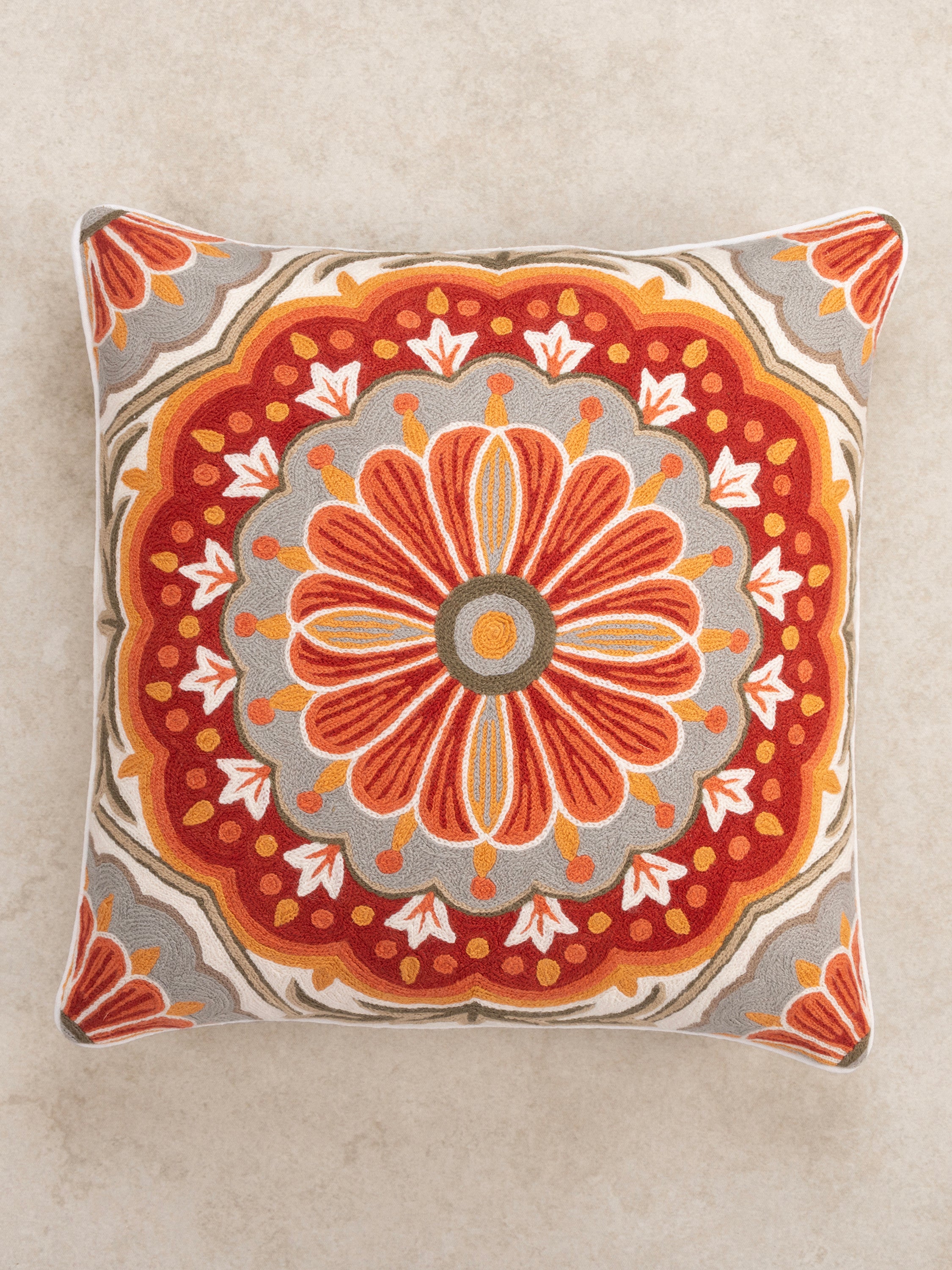 Luxury decorative cushion with intricate embroidery, showcasing a symmetrical bohemian-style pattern for a stylish home accent