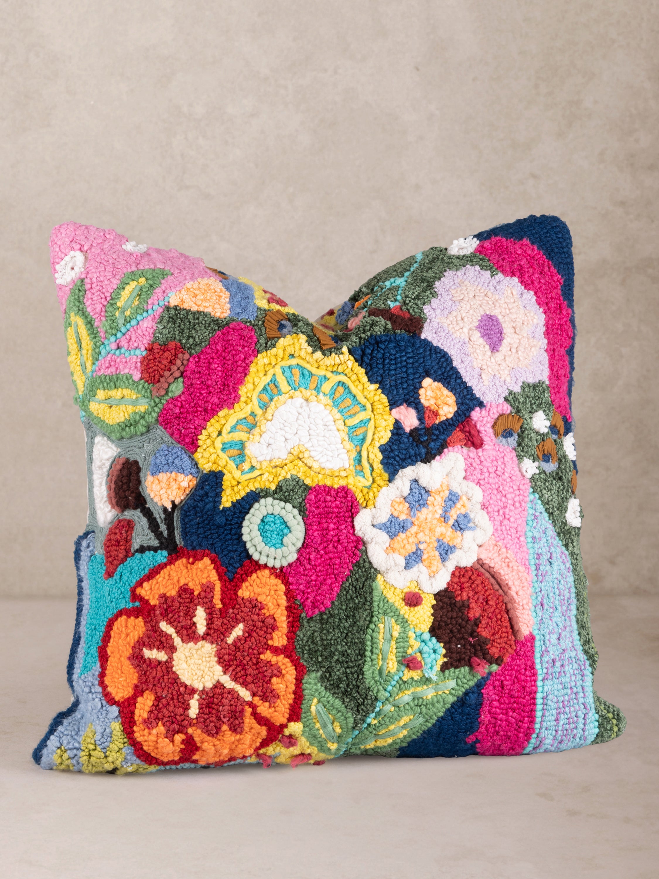 Vibrant multicolor tufted throw pillow featuring an abstract floral embroidery design, perfect for adding a bold statement to any space