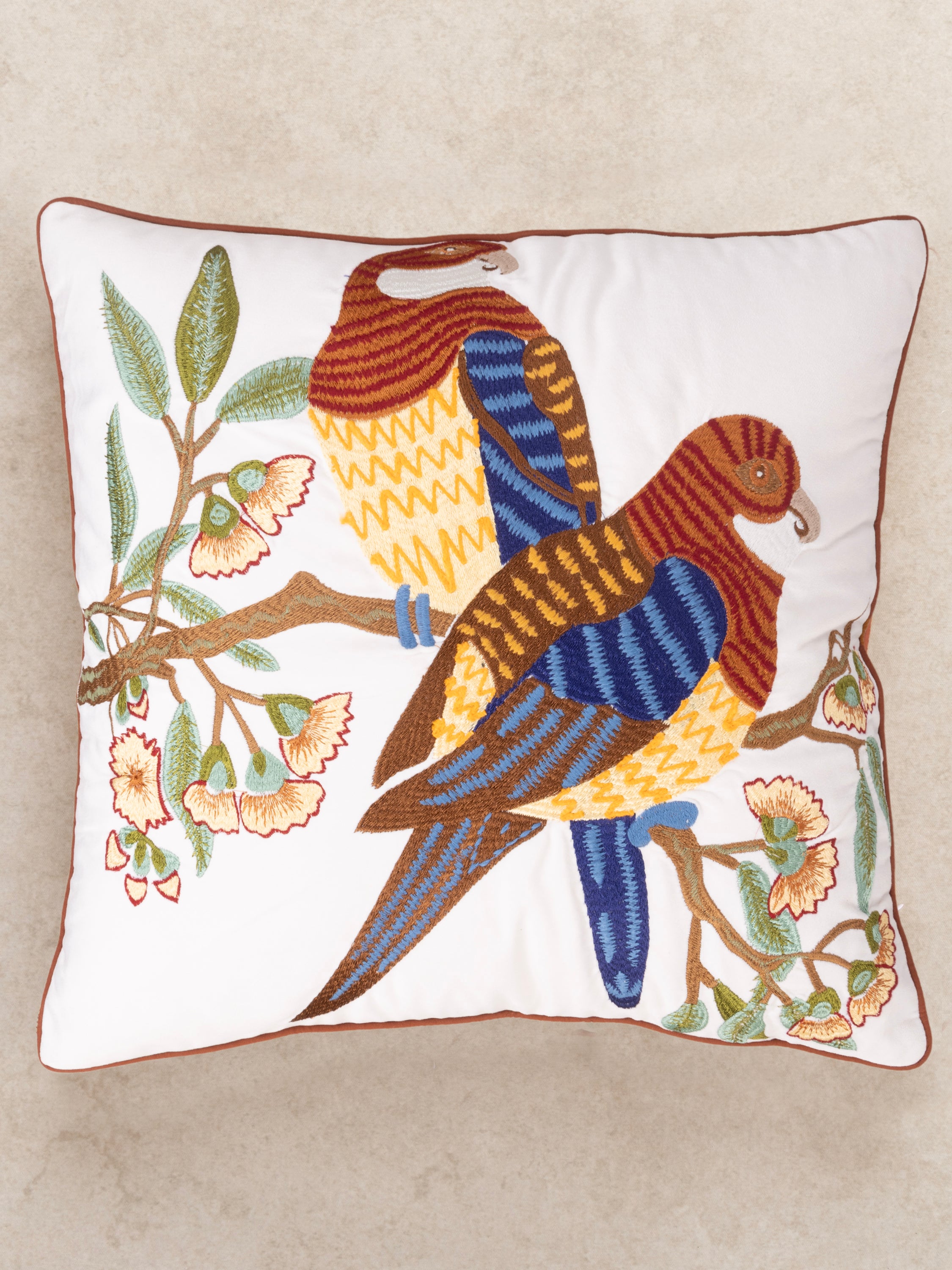 Hand-stitched embroidered cushion with a striking bird and floral motif, ideal for enhancing living room or bedroom decor