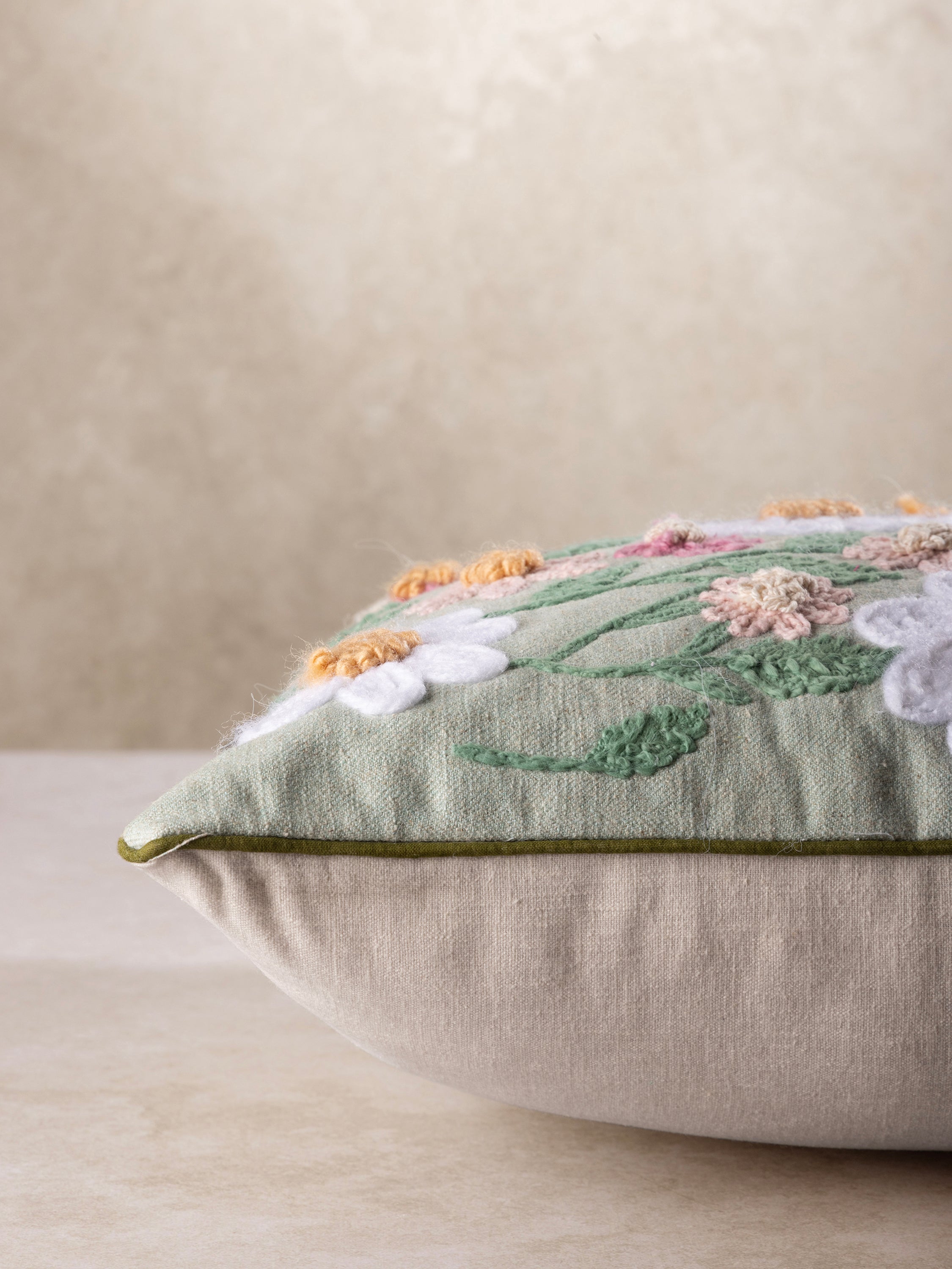 Soft Cotton Floral Pillow with Raised Embroidery & Pastel Colors – A timeless accent cushion with intricate stitching, vibrant hand-embroidered flowers, and leafy details on a muted sage fabric