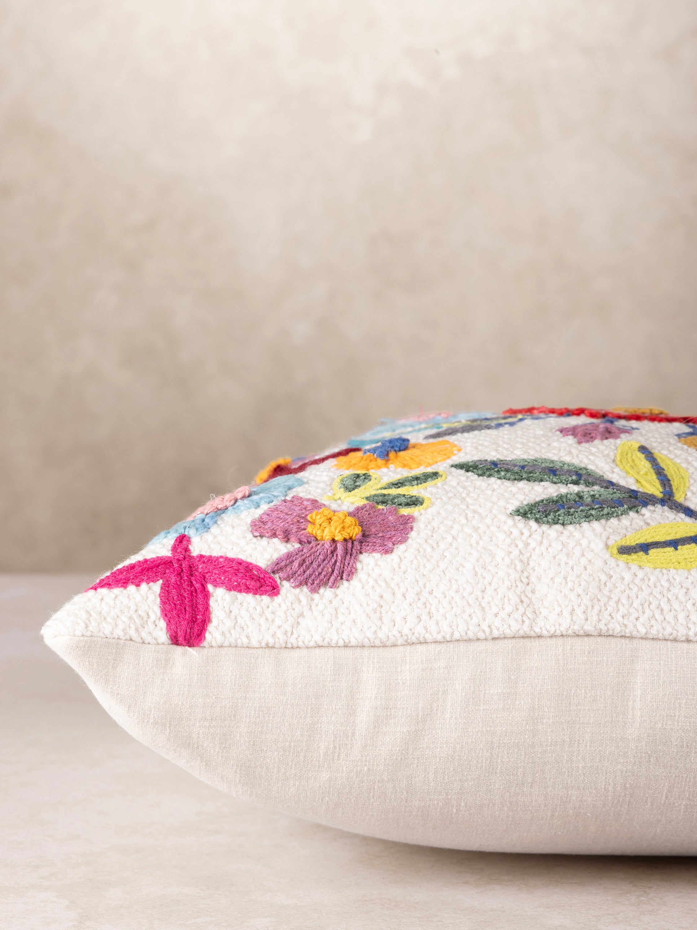 Textured Multicolor Floral Throw Pillow with Boho Charm – A high-quality decorative pillow featuring a lively mix of embroidered flowers and leaves, adding a touch of nature to any space