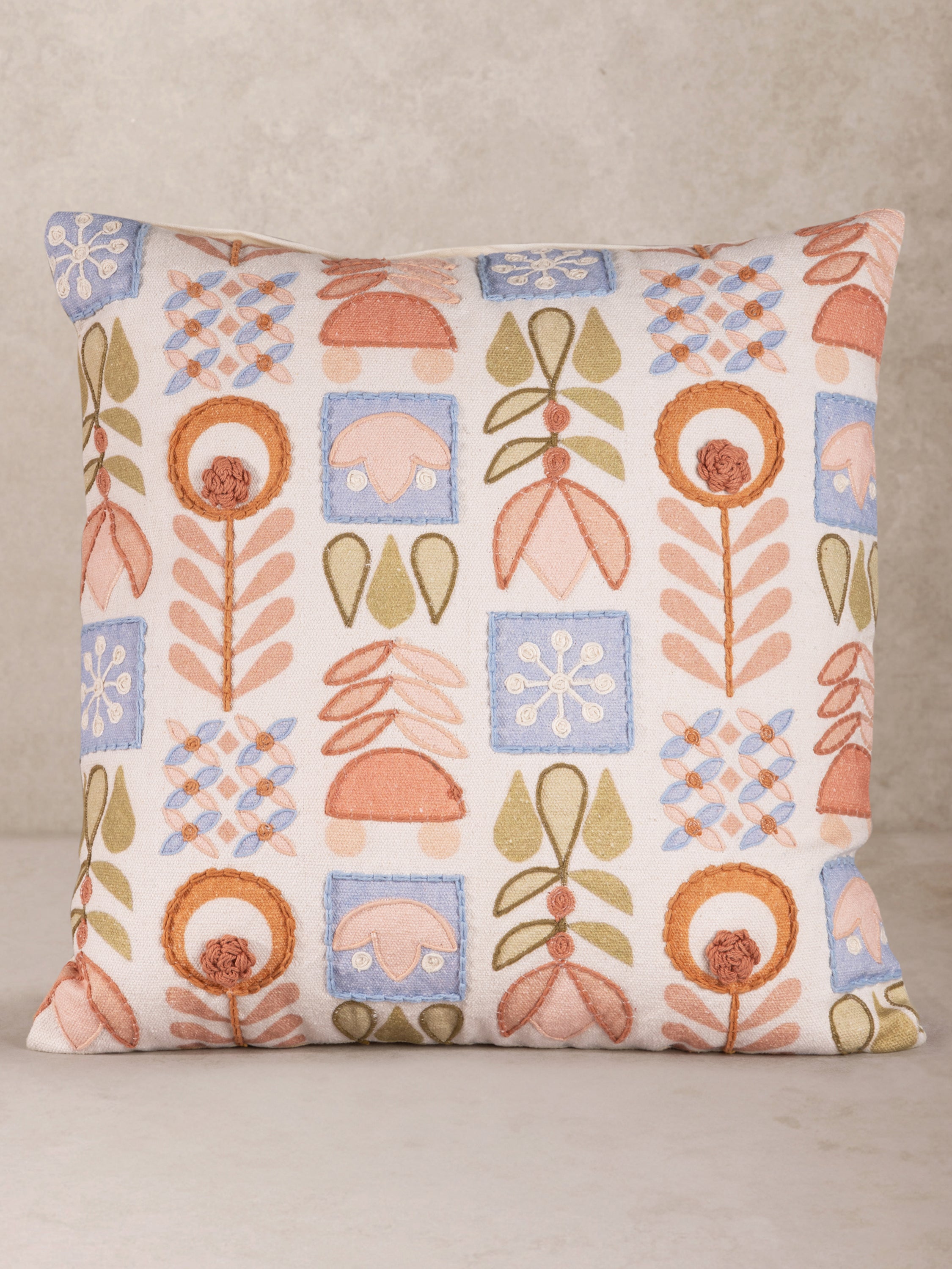 Hand-Embroidered Geometric Floral Throw Pillow in Soft Pastels – A beautifully crafted decorative pillow featuring intricate floral and geometric embroidery in soothing peach, blue, and green tones