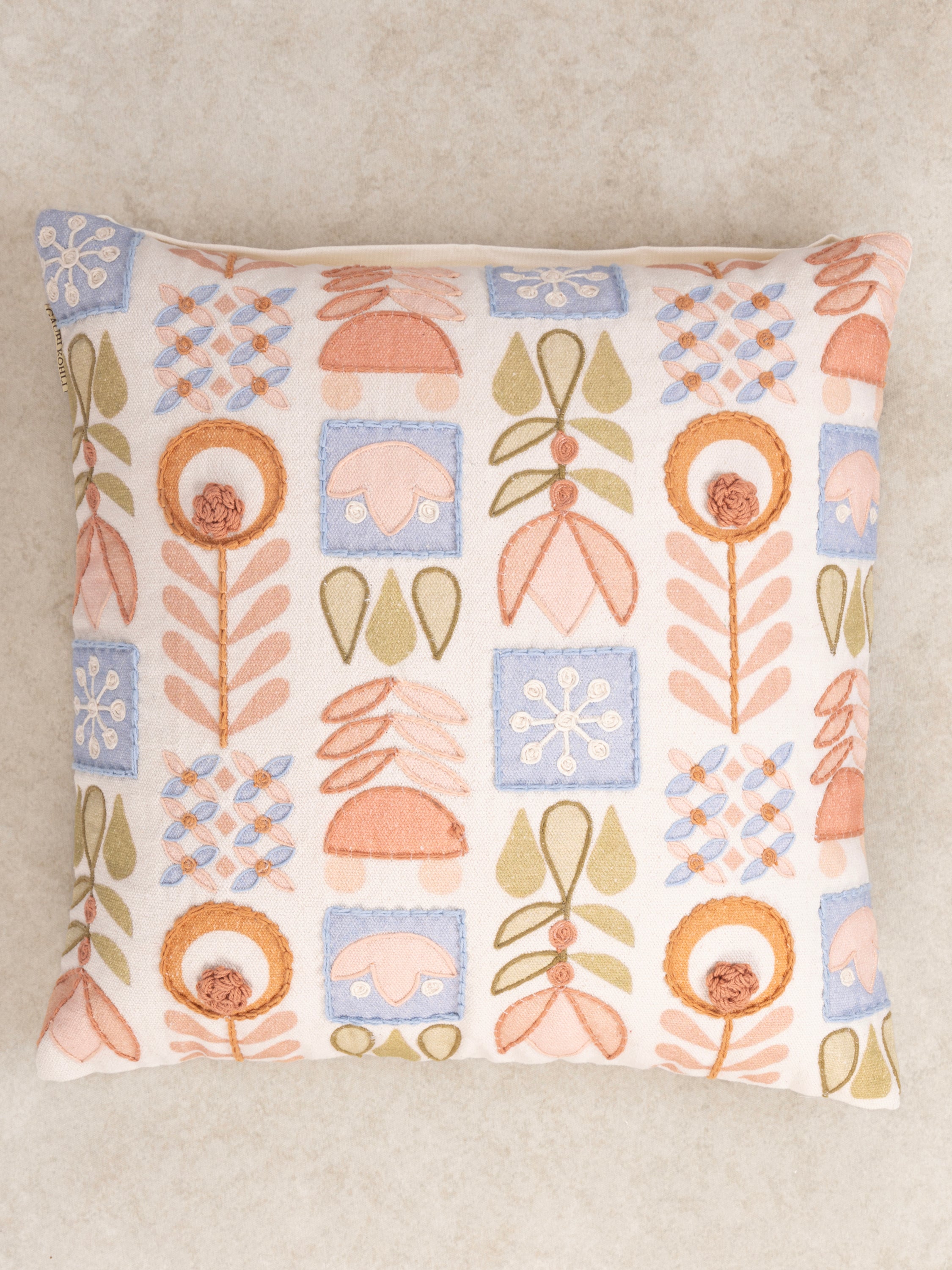 Boho-Inspired Patterned Pillow with Embroidered Botanical Motifs – A stylish and cozy accent cushion showcasing a unique mix of hand-stitched flowers, leaves, and geometric designs on a soft cream fabric
