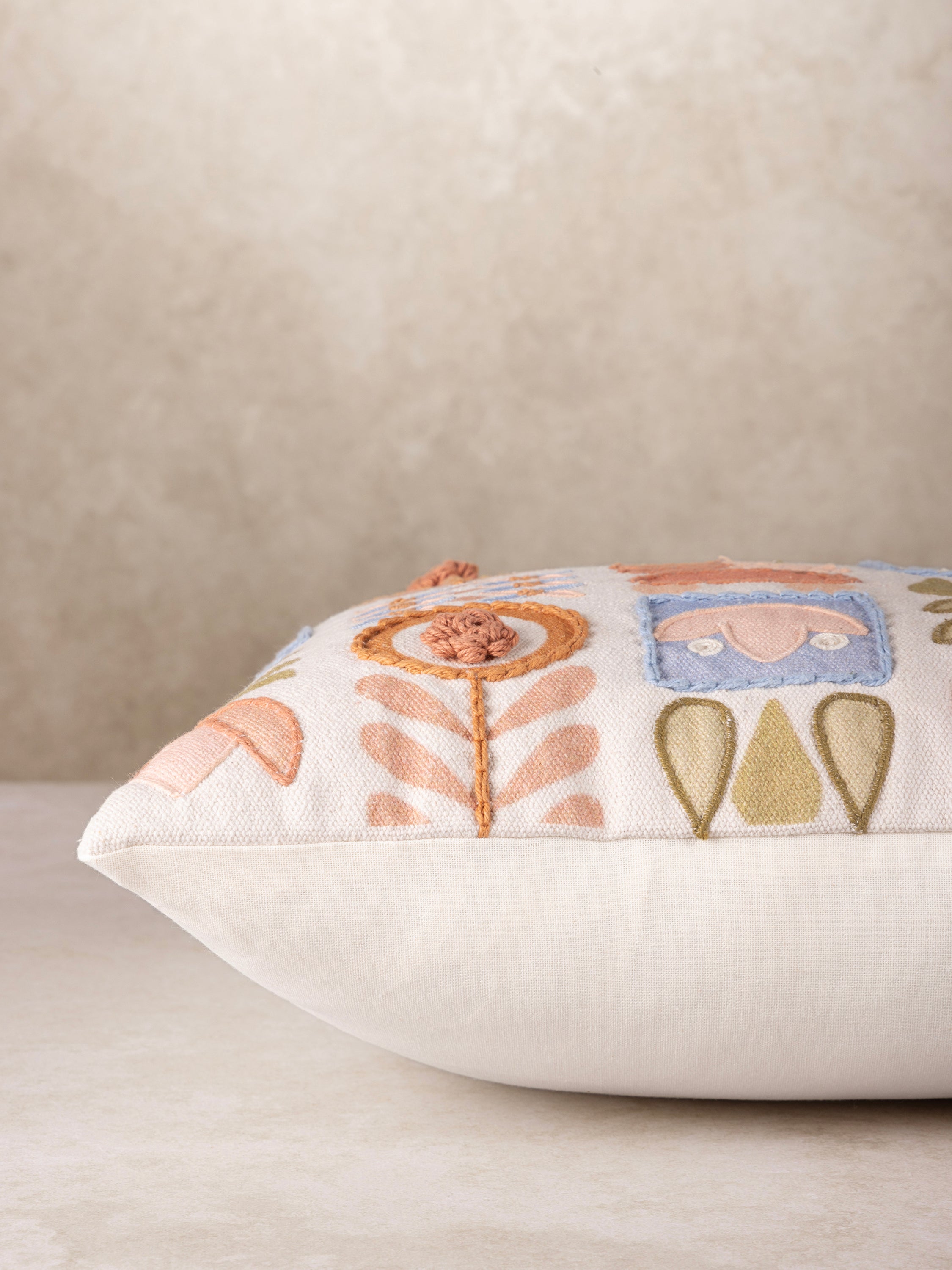 Artisan Tufted Throw Pillow with Modern Folk-Inspired Embroidery – A high-quality decorative pillow with a textured applique design featuring delicate floral patterns and earthy tones for a bohemian aesthetic