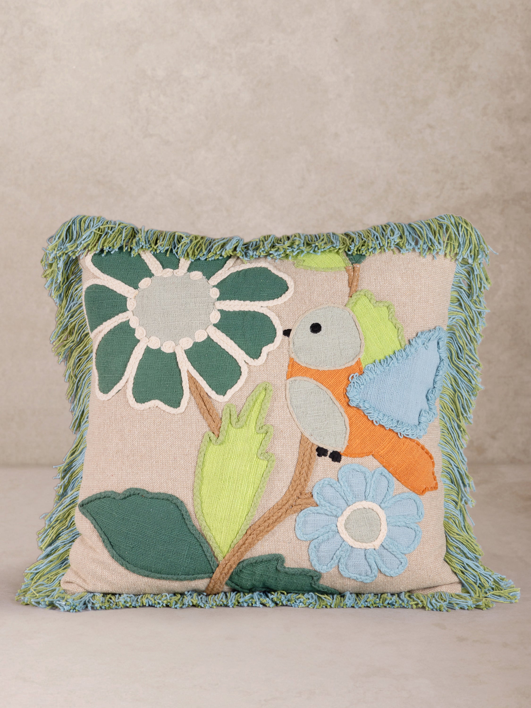 Embroidered Bird & Floral Throw Pillow with Fringe Trim – A beautifully handcrafted decorative pillow featuring a charming bird and floral design with textured embroidery and soft green fringe