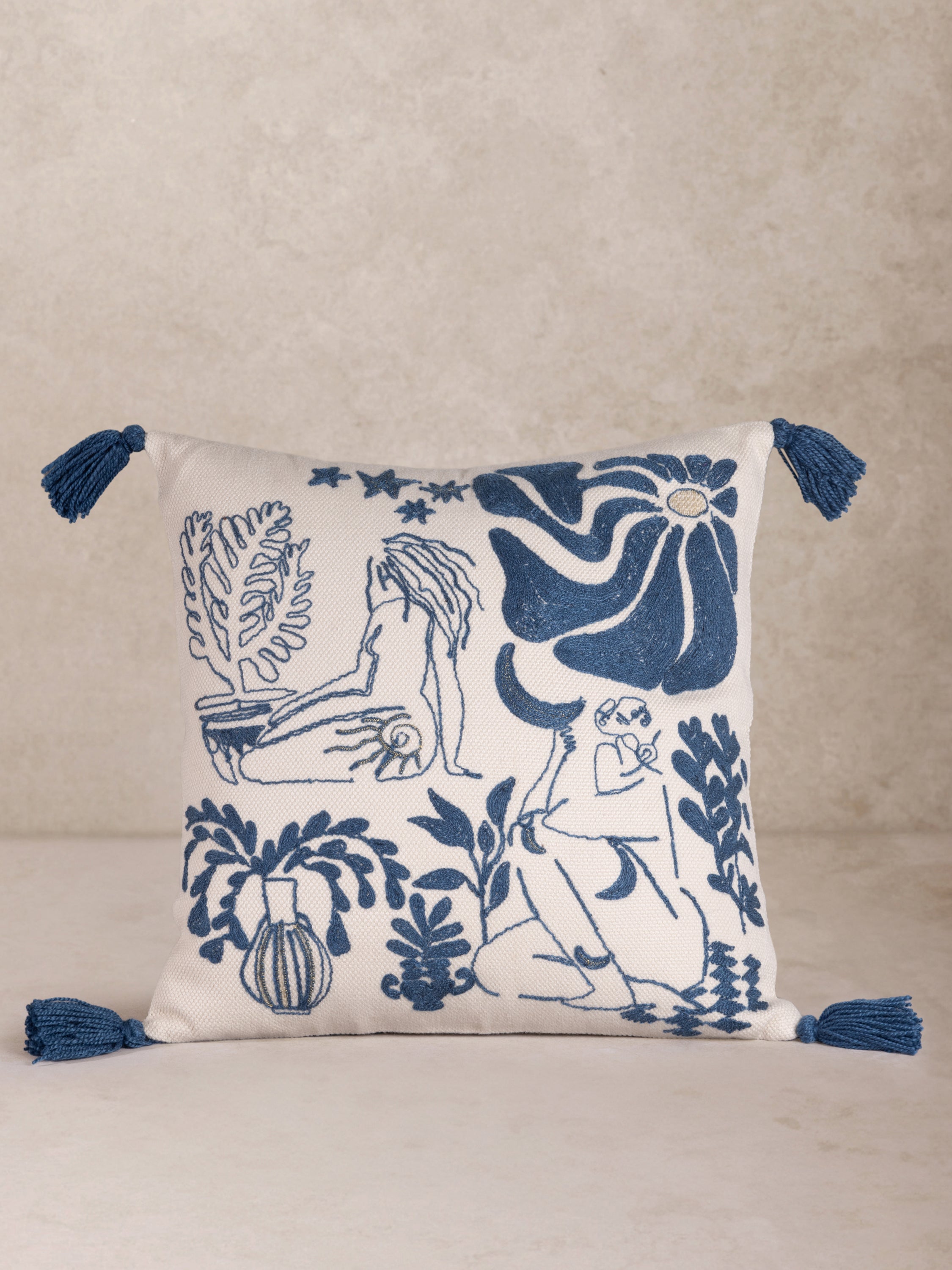 Minimalist Embroidered Throw Pillow with Abstract Line Art Design – A stylish decorative pillow featuring a modern embroidered sketch of human figures and botanical elements in deep blue on a soft cream background