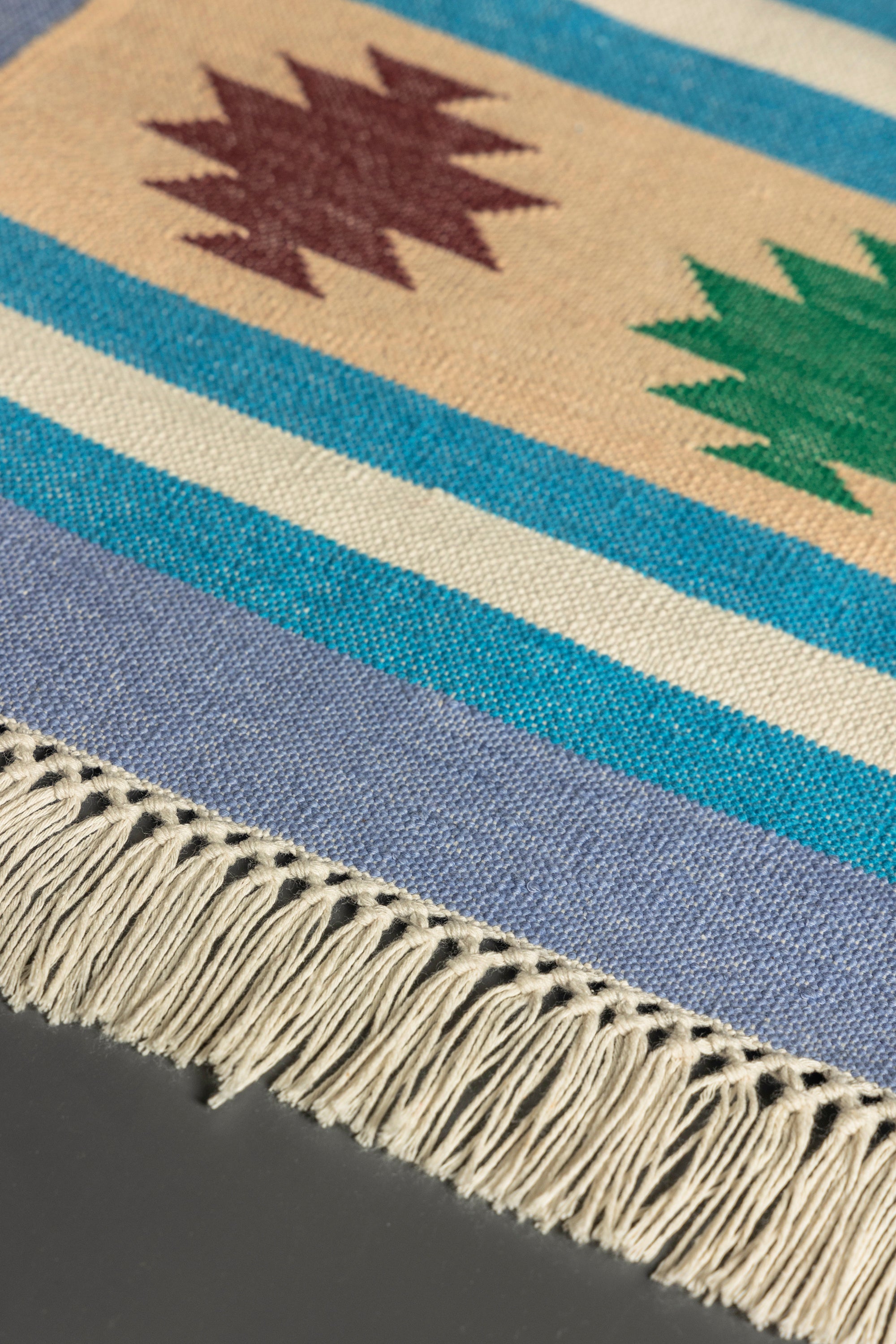 Southwestern-inspired kilim runner rug with bold hues and decorative fringe edges
