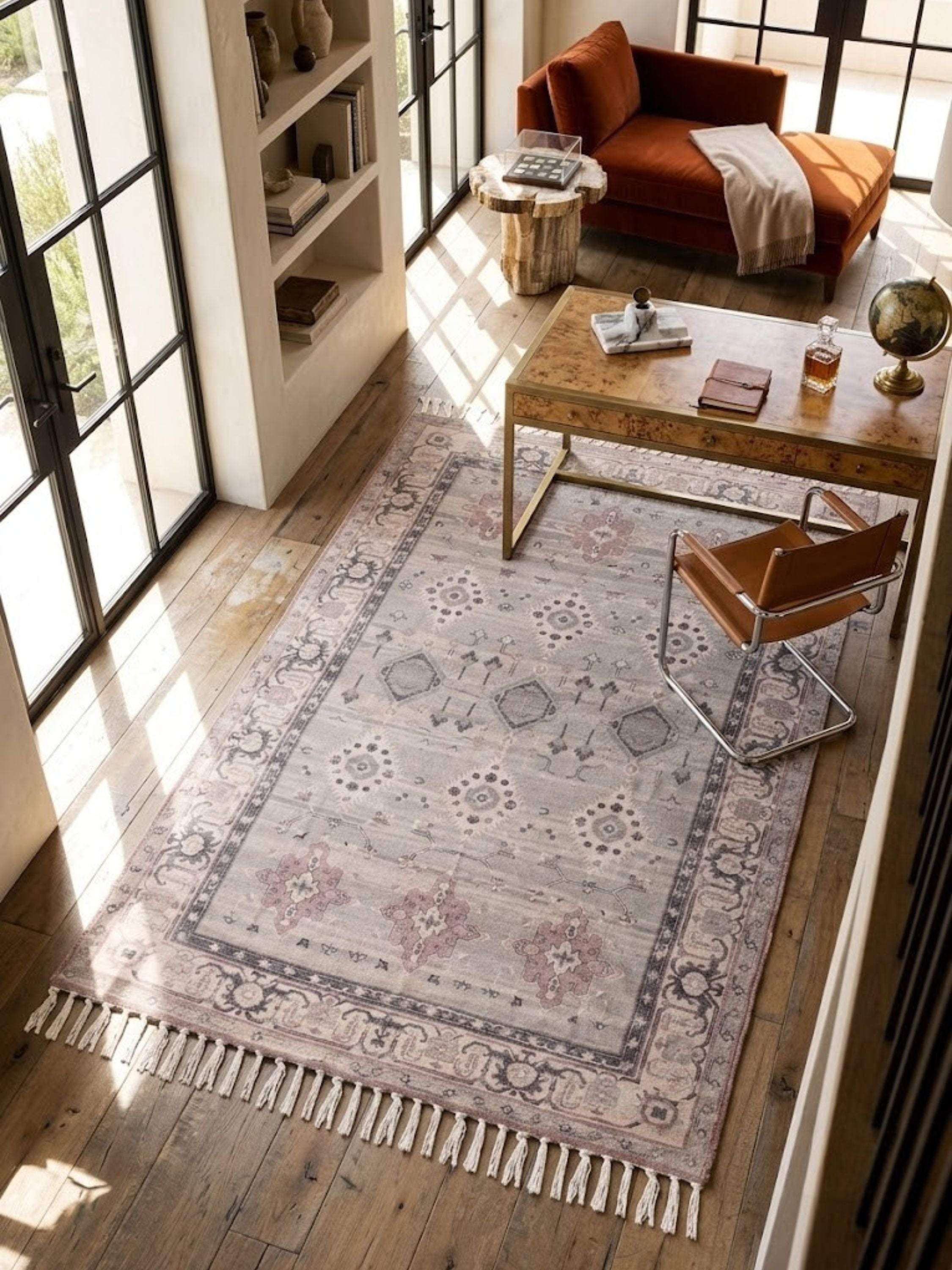 Low-profile cotton and viscose rug styled on a light-filled room floor beside furniture.