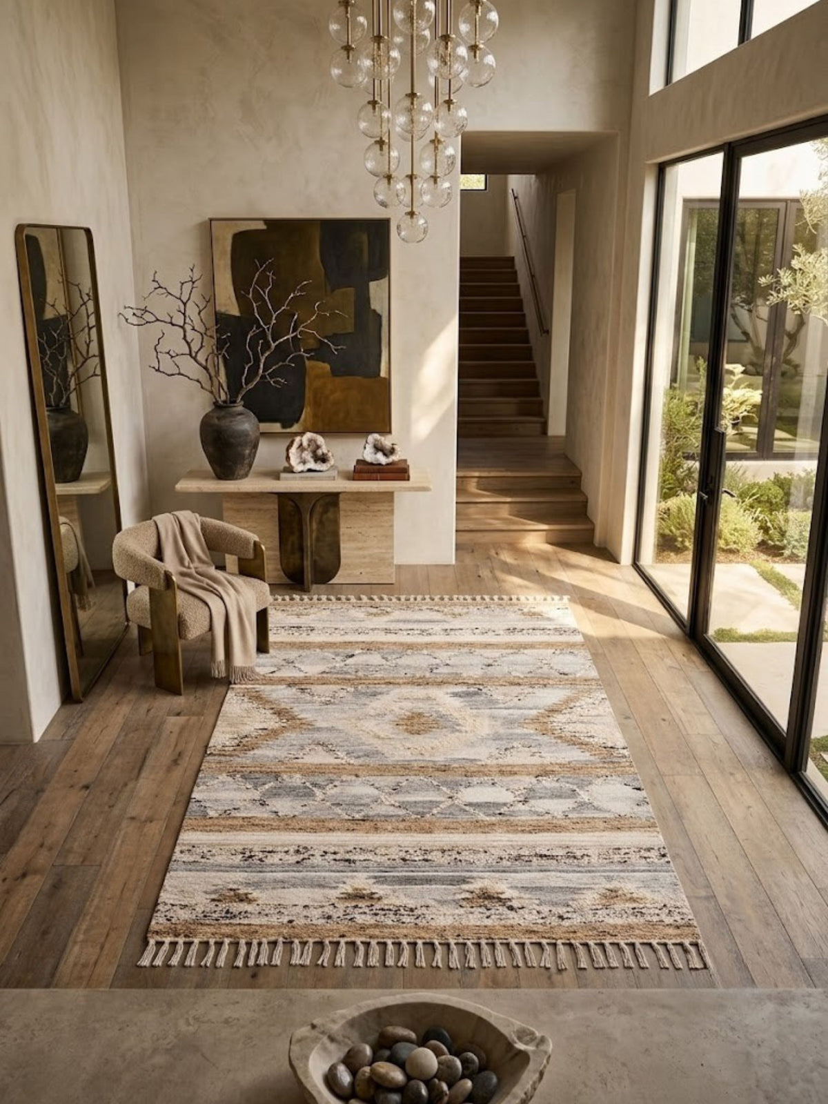 Wool, cotton, and jute rug, banded geometric pattern, styled at an entryway beside a staircase.