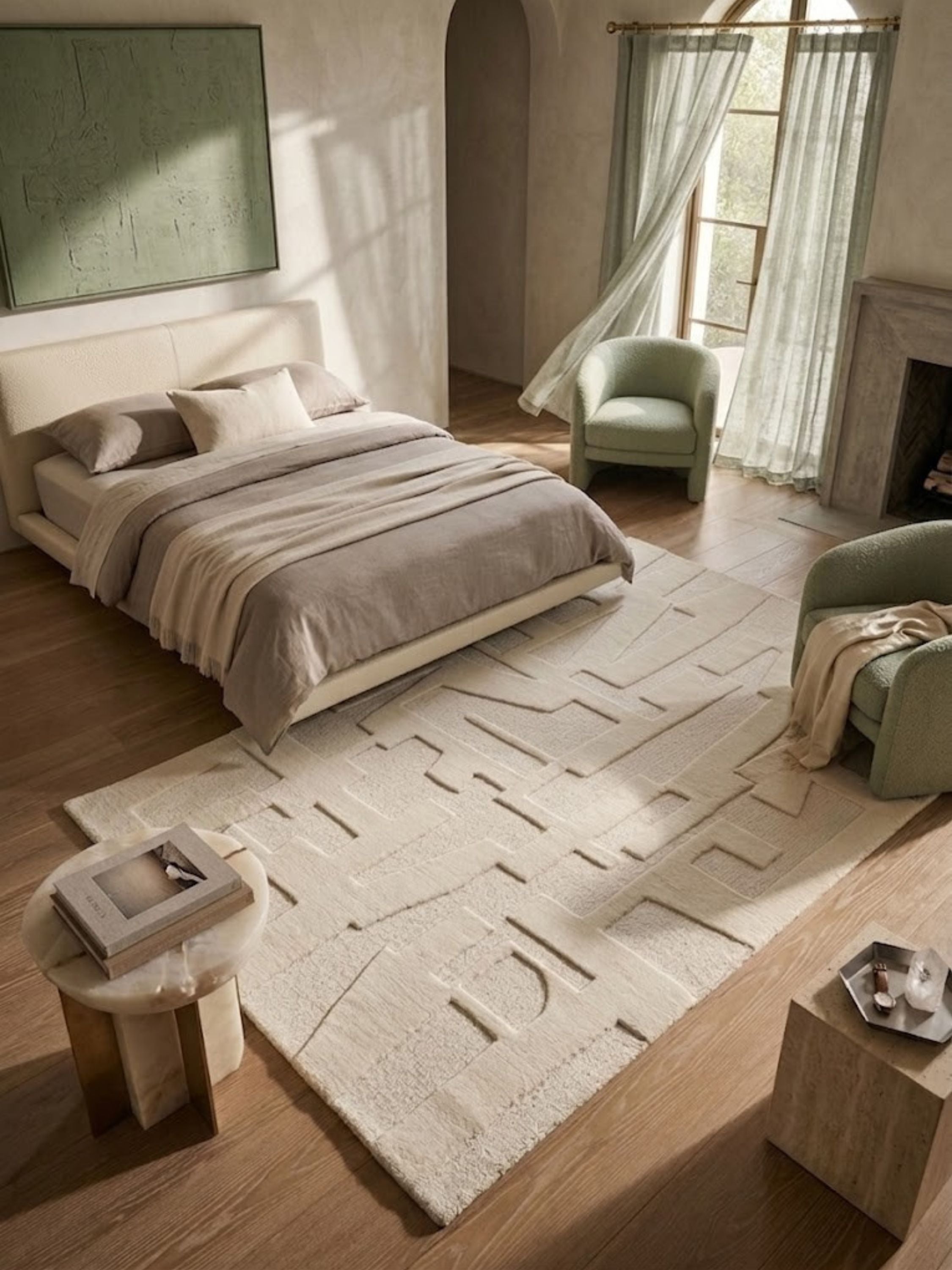 Ivory wool and cotton rug in a tonal ivory colorway, styled in a guest bedroom.