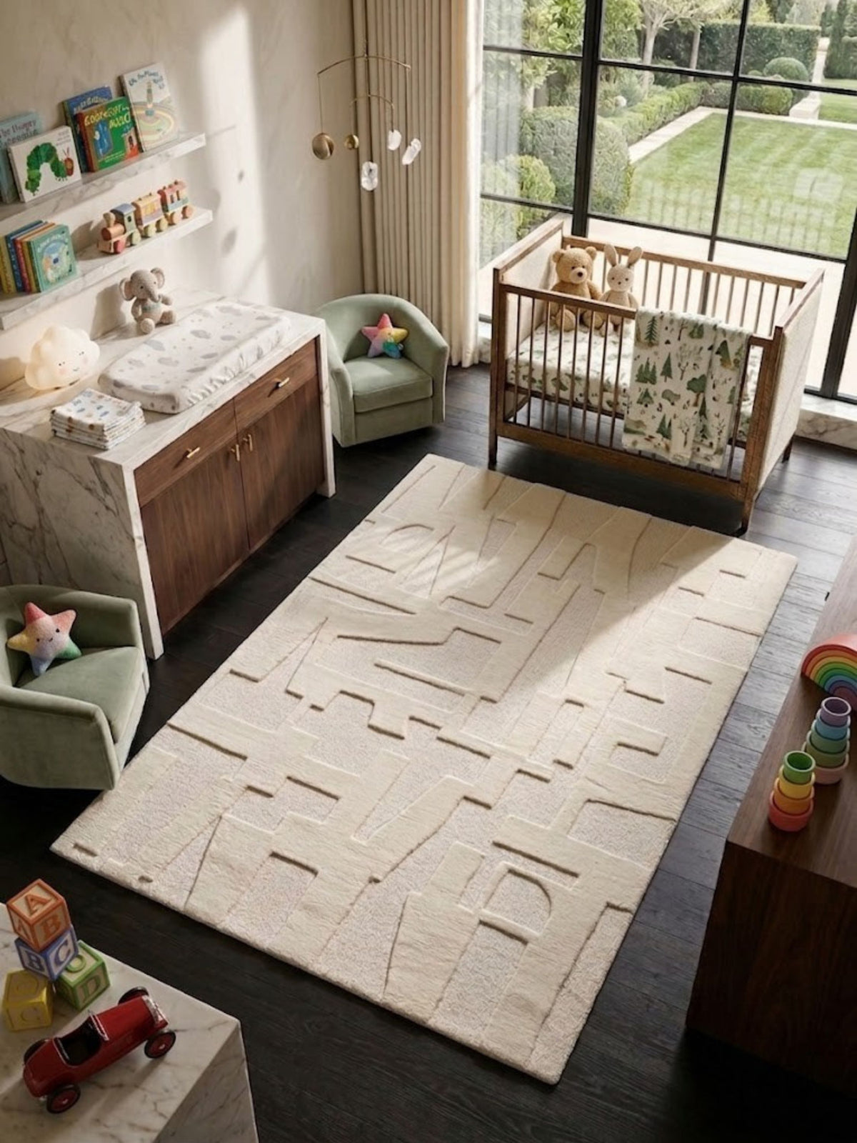 Ivory wool and cotton rug with a non-repeating abstract pattern, styled in a nursery.