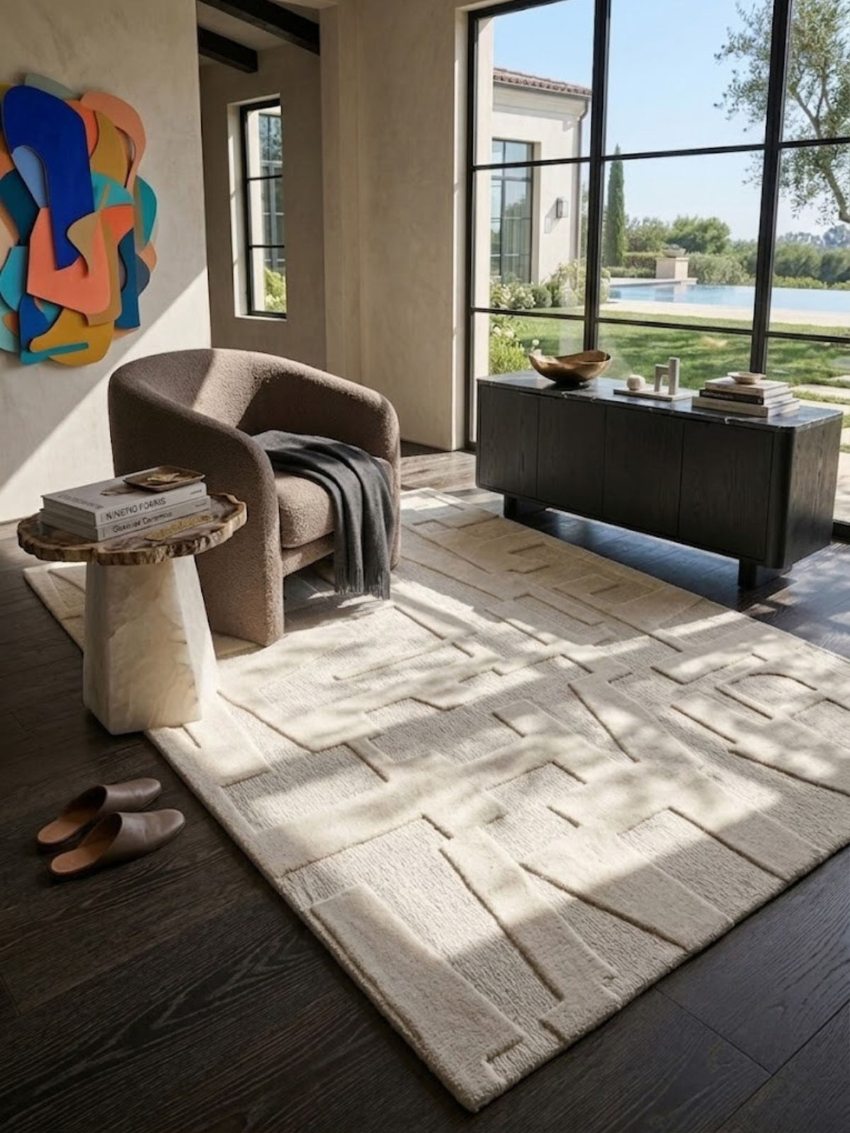 Ivory wool and cotton rug with a textured high-low weave, styled in a reading nook.