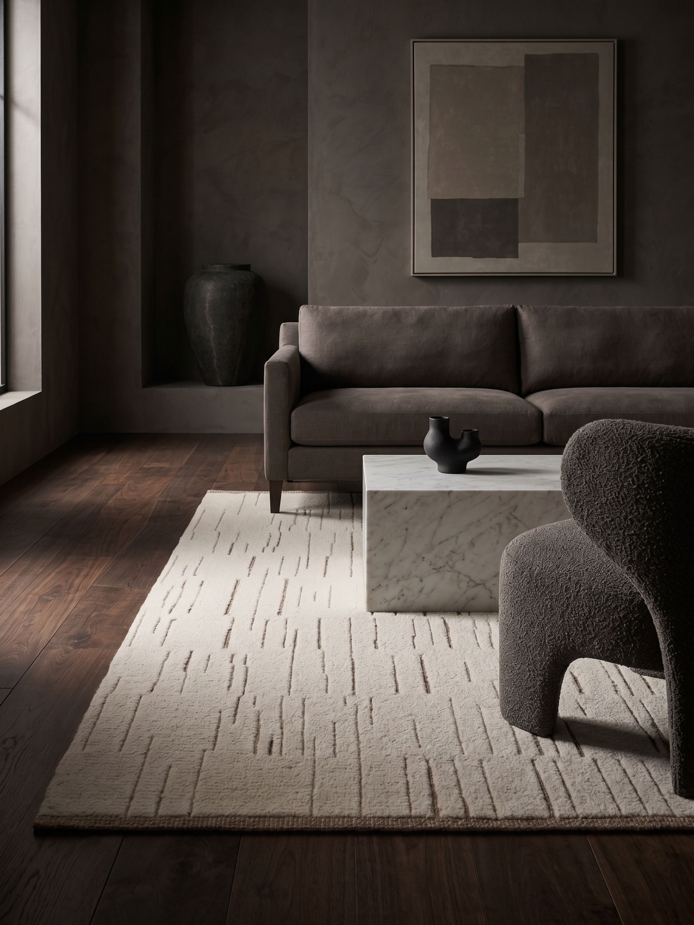 Hand tufted wool and jute area rug in ivory with subtle linear carved texture styled in a modern living room