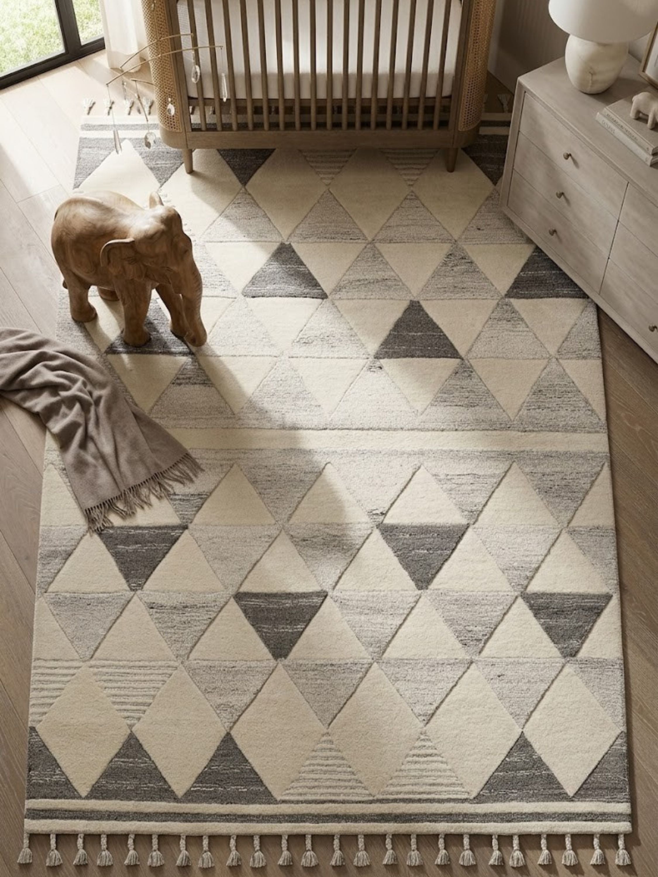 Wool and cotton rug in charcoal and ivory, styled in a cozy interior setting.