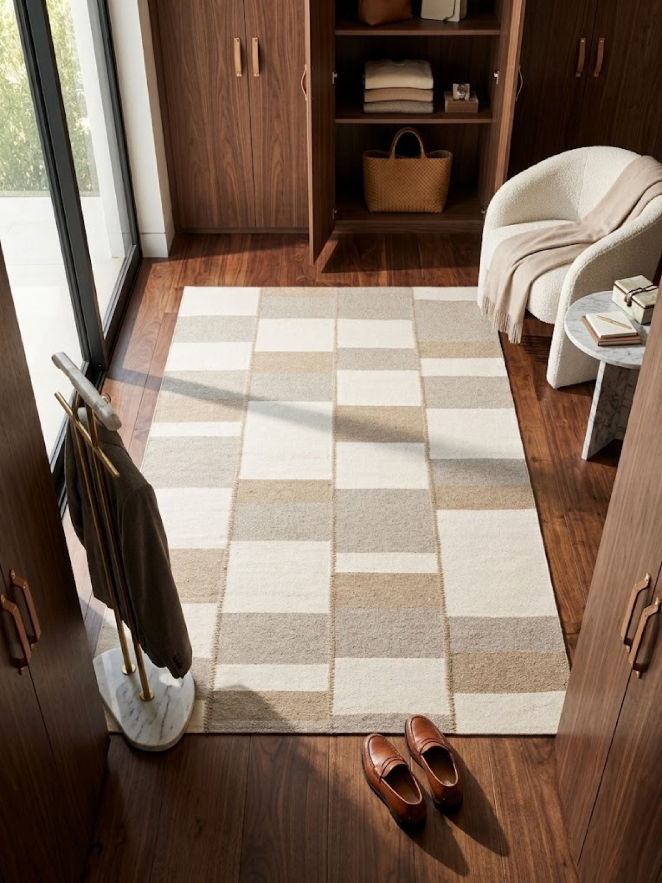Wool rug with a raised woven seam at each block boundary, styled in a light-filled room.