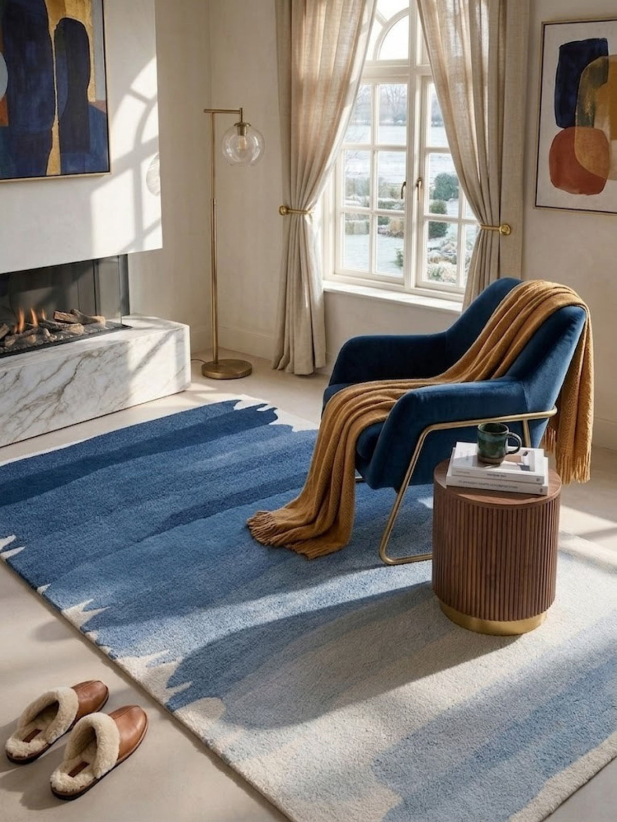 Navy-to-ivory wool rug, dense close-cropped pile, positioned in a living room beside a navy velvet armchair.
