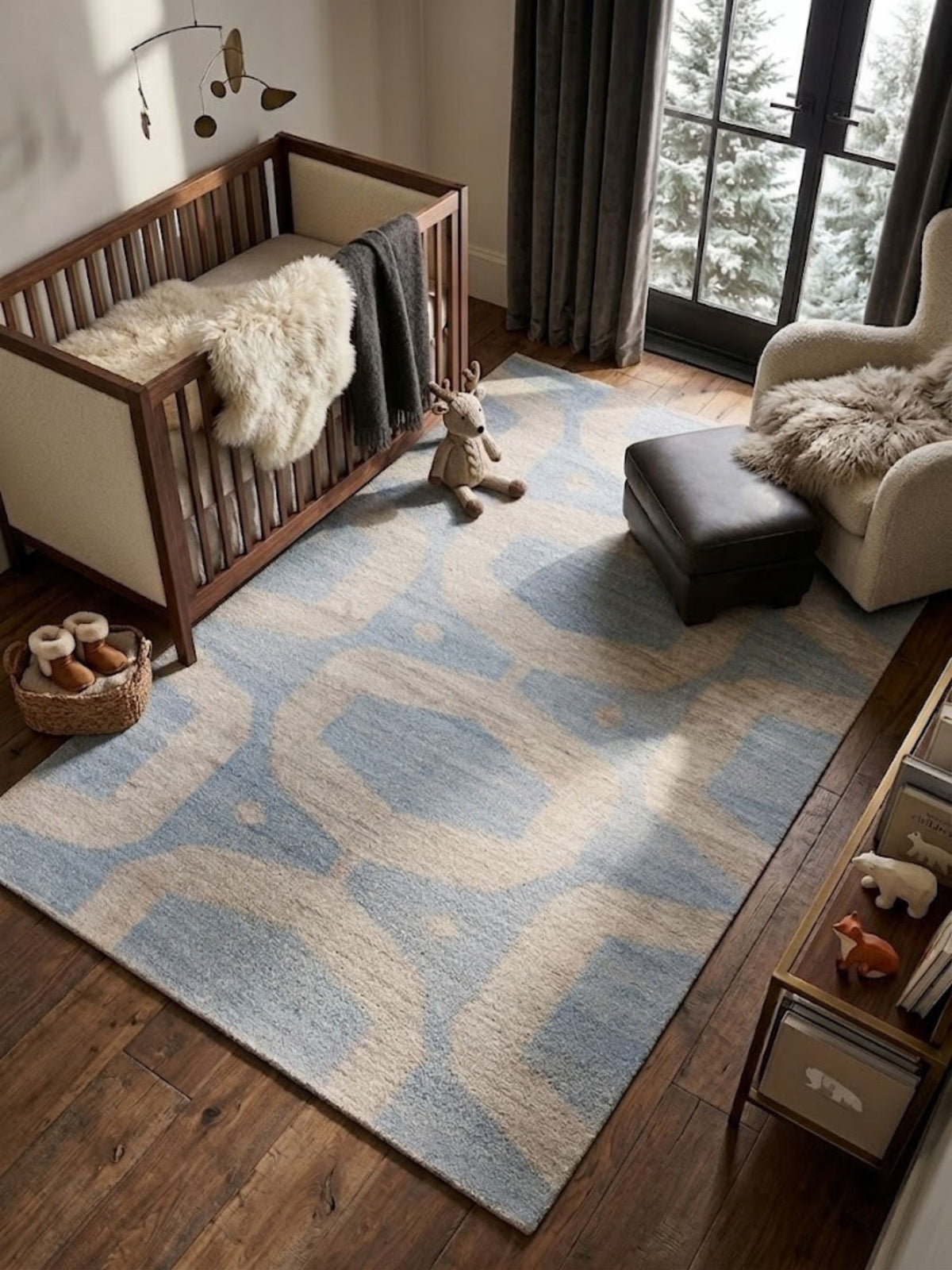 Flatwoven wool rug shown in partial view, arch and oval pattern in blue and sand, styled near furniture and a plant.