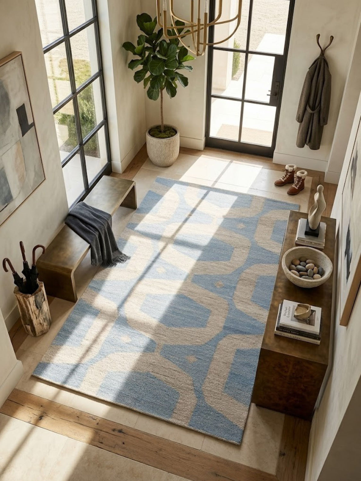 Flatwoven wool rug with an interlocking pattern in blue and sand, styled near a table.