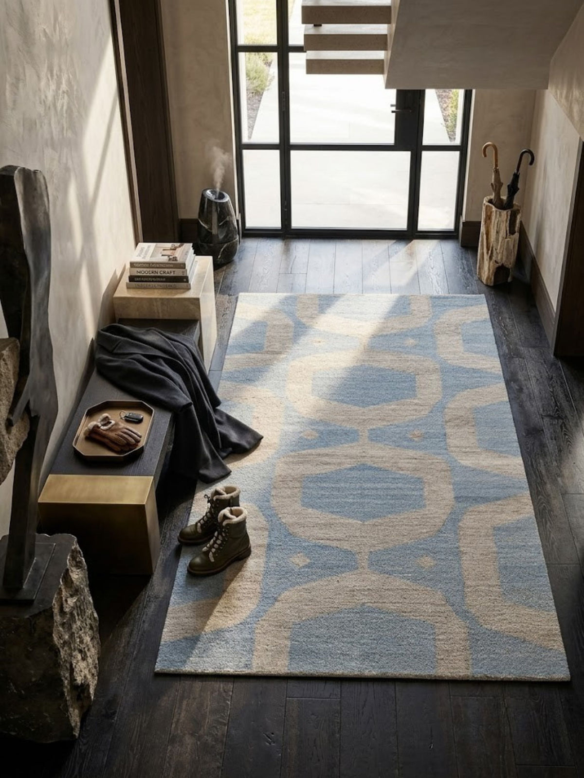 Flatwoven wool rug with a compact weave in blue and sand, styled on a wood floor with nearby seating.