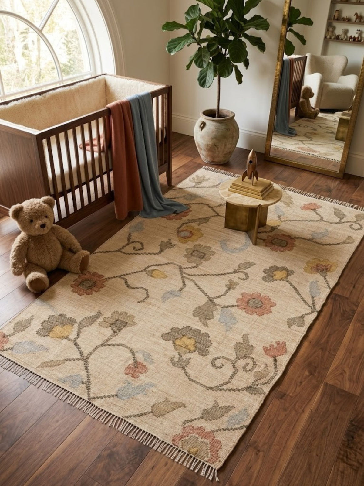 Wool and jute rug with a botanical trail pattern, styled beside a crib.