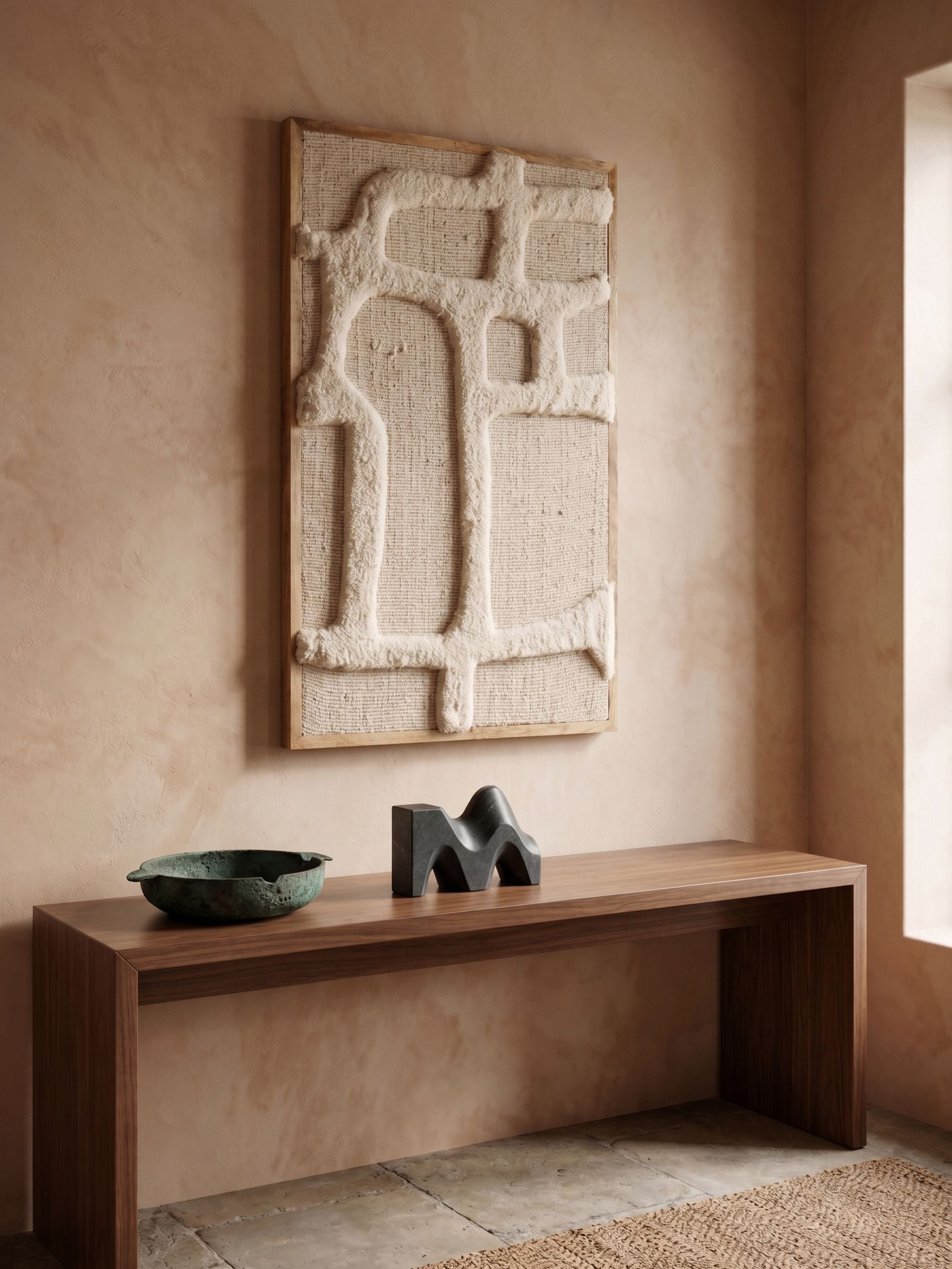 Ivory tufted wool wall art with abstract raised texture, placed above a wooden console against a warm plaster wall