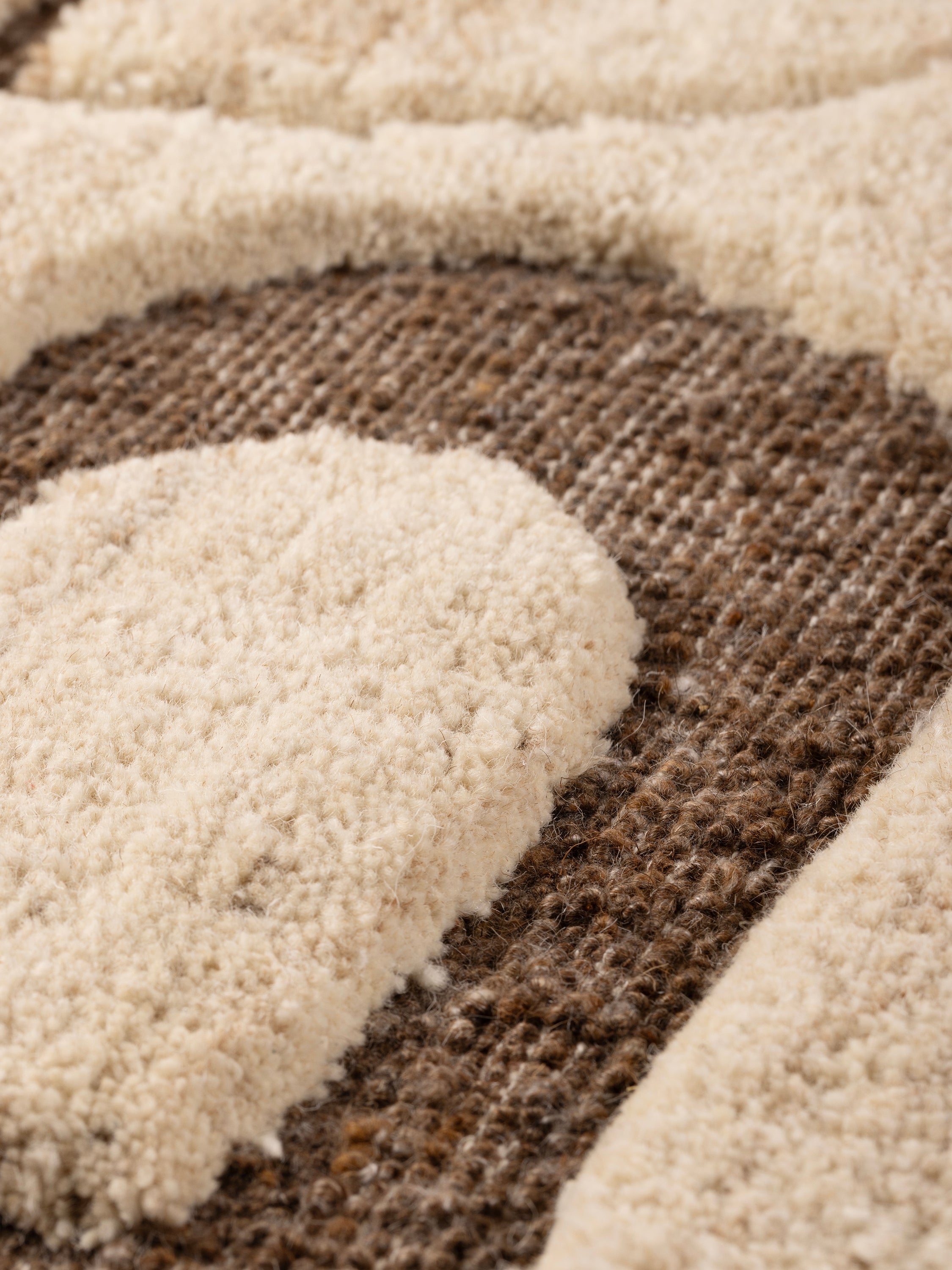 angled view showing depth of tufting and textured wool base