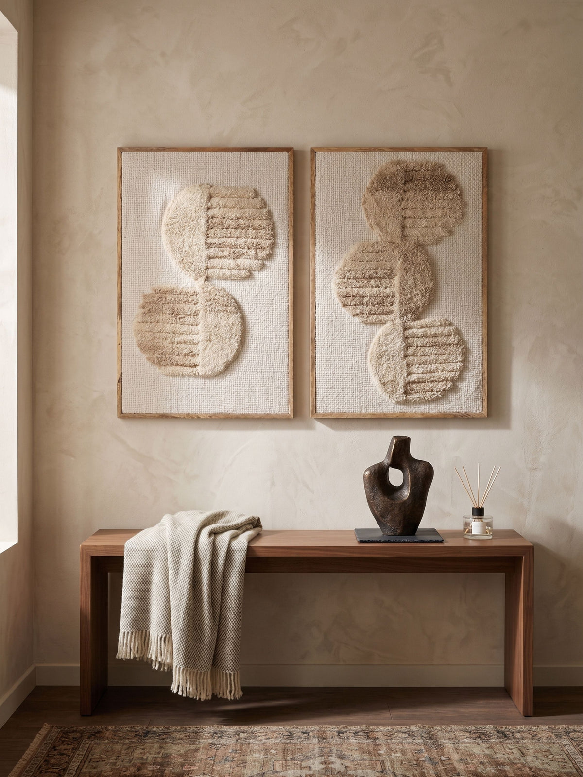 Set of two ivory and sand tufted wool wall art panels, displayed together above a wooden console.