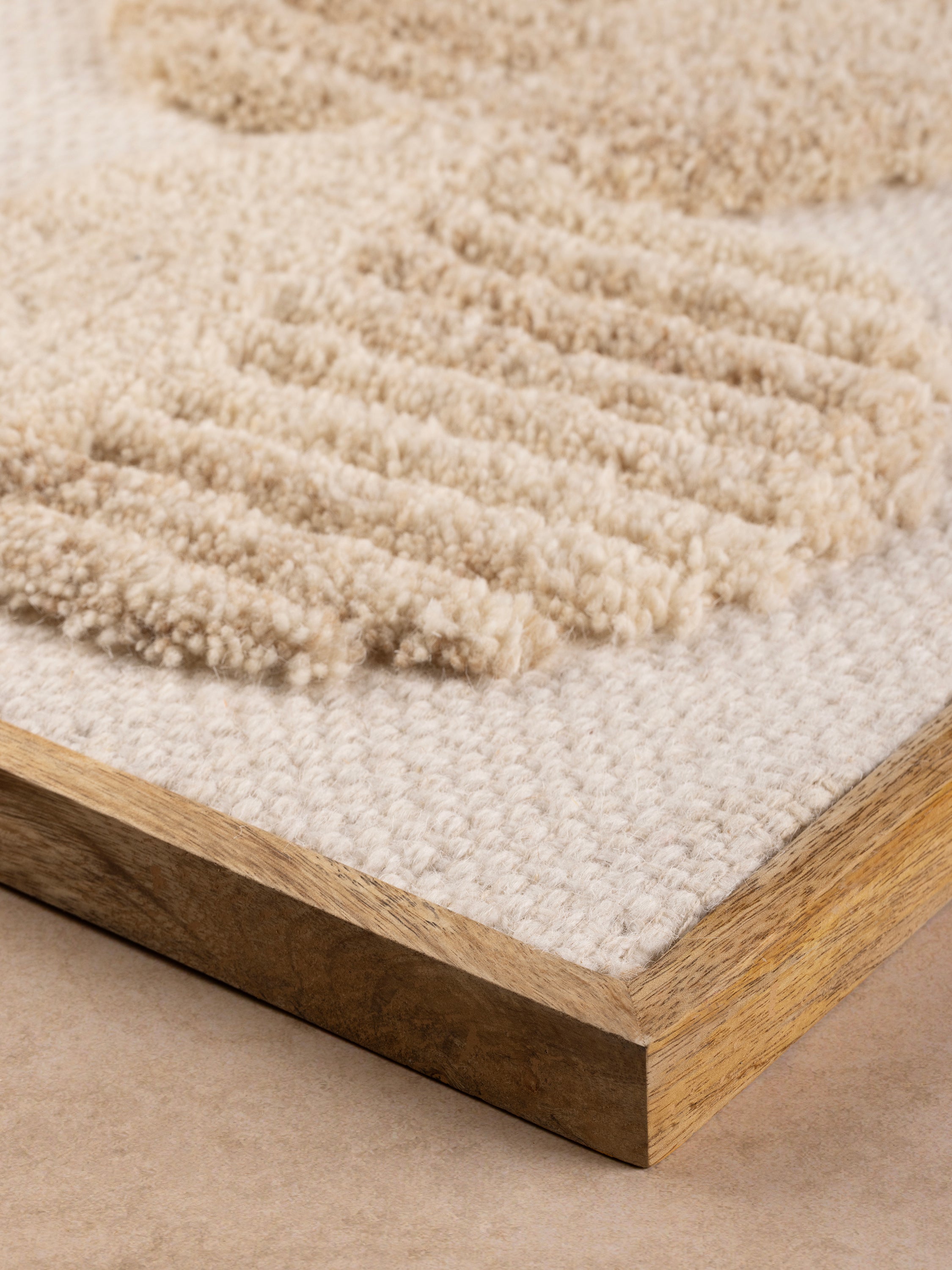detailed corner view showing wood frame and textural wool surface