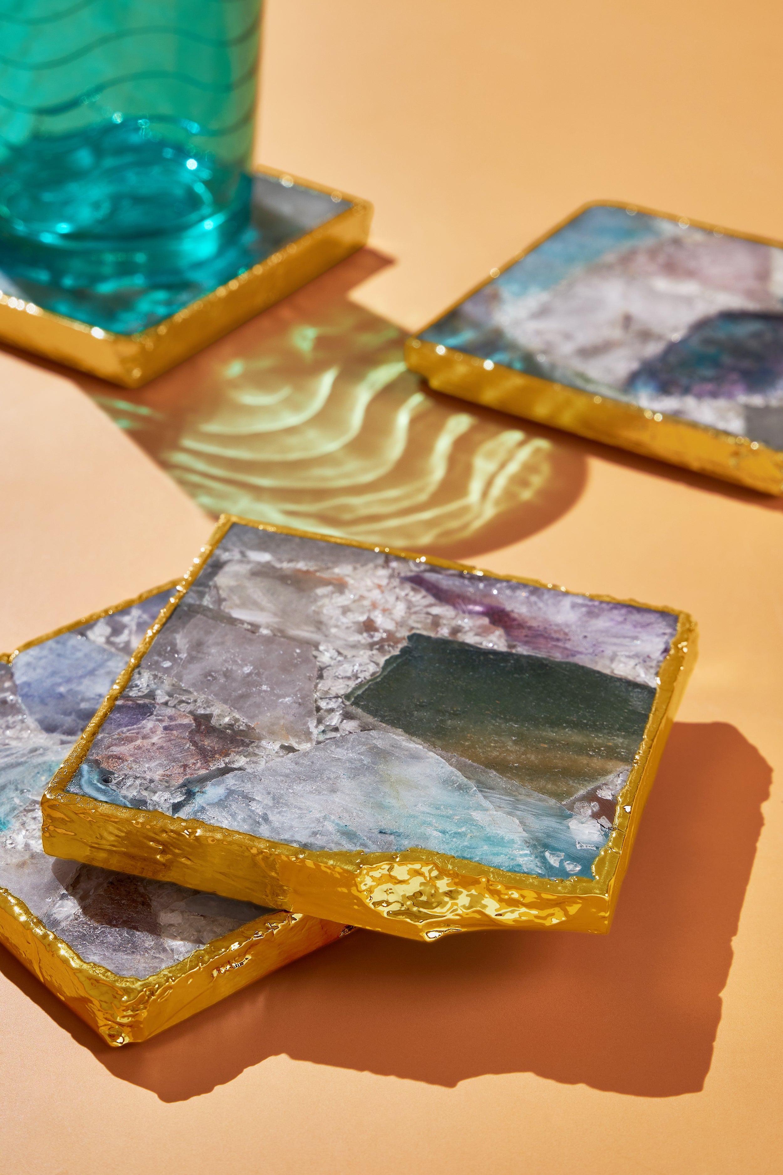 Vibrant Crystal Coasters – Elegant Gold Rimmed Stone Coaster Set
Handmade crystal coasters featuring a mix of colorful gemstones, making them a perfect addition to any coffee table or bar
